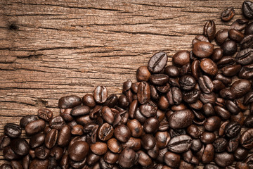 Coffee beans on wood background