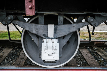 Fototapeta na wymiar Black wheels of an old Russian locomotive on the rails close-up.