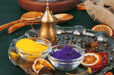 Obraz na płótnie Canvas Traditional Indian Holi colours powder, spices on dark rustic background