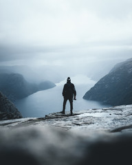 Person looking into the distatant fjord preikestolen norway