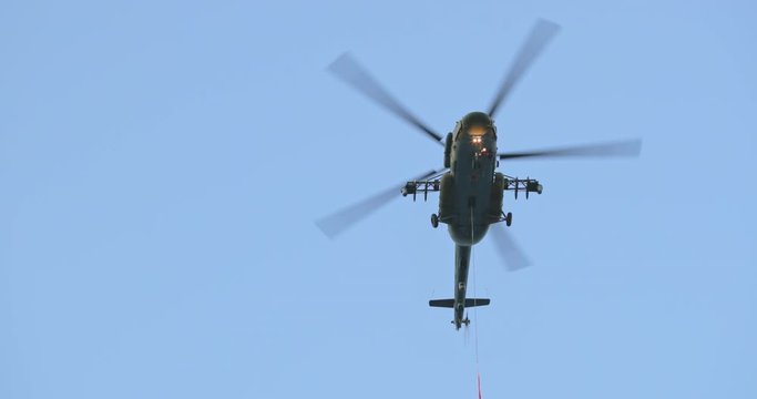 Column of four military helicopters flies over the ground. Military helicopters and planes in the evening sky. Air force parade. Independence Day parade in the CIS country. Belarus 3 July 2019.