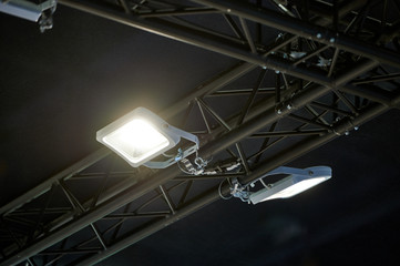 Bright lights attached to black truss