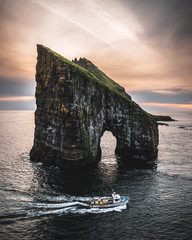 Drangarnir Faroe islands with a boat in front