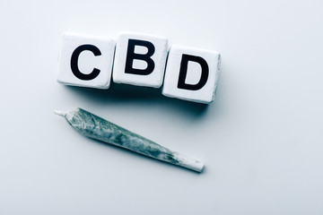 top view of cubes with lettering cbd and blunt on white background