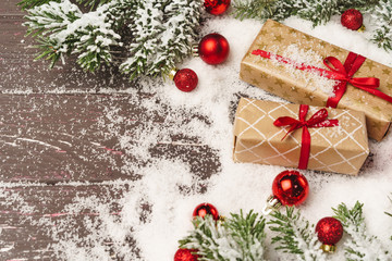 Christmas gift on wooden table powdered with snow