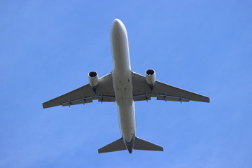 White Russian Passenger two turbine jet aircraft with flaps fly against blue sky close up bottom view, aviation logistics