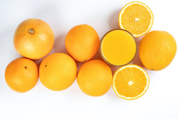 Fresh orange juice in glass on white yellow background