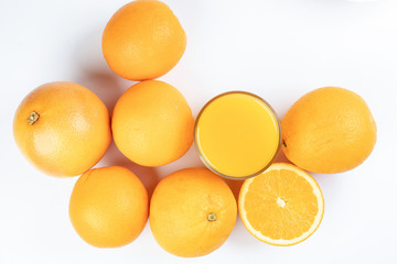 Fresh orange juice in glass on white yellow background
