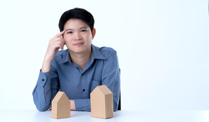 business smart asian man with house model on table house business dicision white background