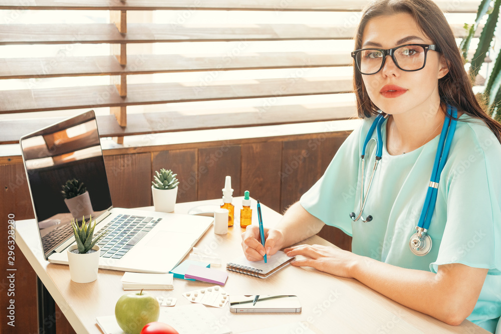 Wall mural female medicine doctor filling patient medical form or prescription