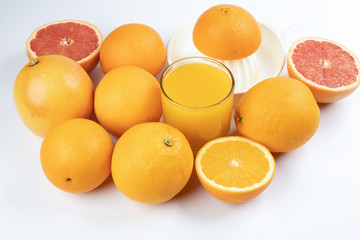 Fresh orange juice in glass on white yellow background