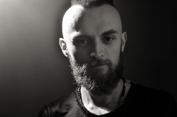 Black and white Portrait of young European hipster with fair skin and trendy ginger beard. Fashionable undercut hairstyle and handsome face features.  Movember concept