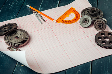 Car parts on graph paper close up. Engineering concept