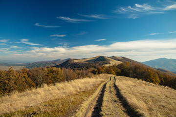 colorful mountain landscape view photography with highland dirt trail and vivid blue sky background 