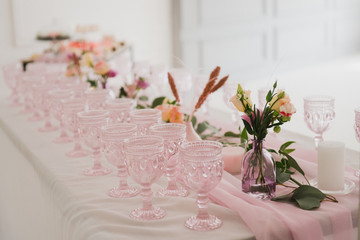 Coziness and style. Modern event design. Table setting at wedding reception. Floral compositions...