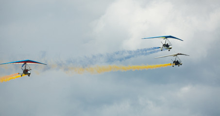 Flex-wing trikes flying in sky on air show