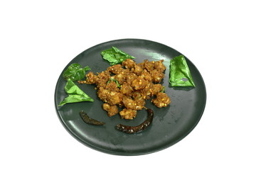 spicy fried chicken tendon with chili and lemon leaf on dish