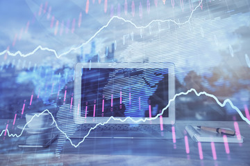 Forex Chart hologram on table with computer background. Multi exposure. Concept of financial markets.