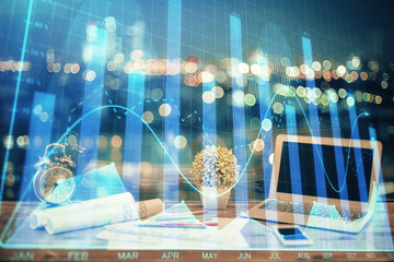 Financial graph colorful drawing and table with computer on background. Multi exposure. Concept of international markets.