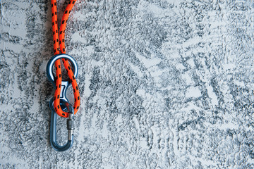 Knot with metal carabiner. Silver colored device for the active sports