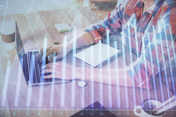 Multi exposure of forex graph with man working on computer on background. Concept of market analysis.