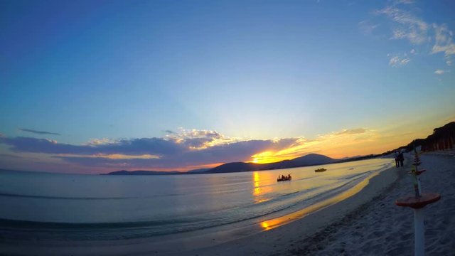 Time lapse video of a colorful sunset in Maria Pia beach. Sardinia, Italy
