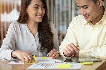 Asian couples are calculating income And expenses To cut unnecessary expenses And planning to borrow money to buy a new home. Concepts for investment planning and financial planning for the family