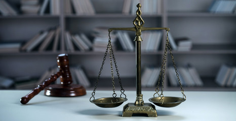 Scale of justice. Wooden judge`s gavel. The criminal law. Low concept