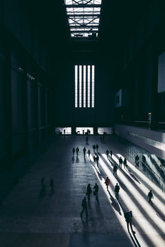 LONDON - APRIL 26, 2018: People Walking In Interior Of Tate Modern Turbine Hall In London