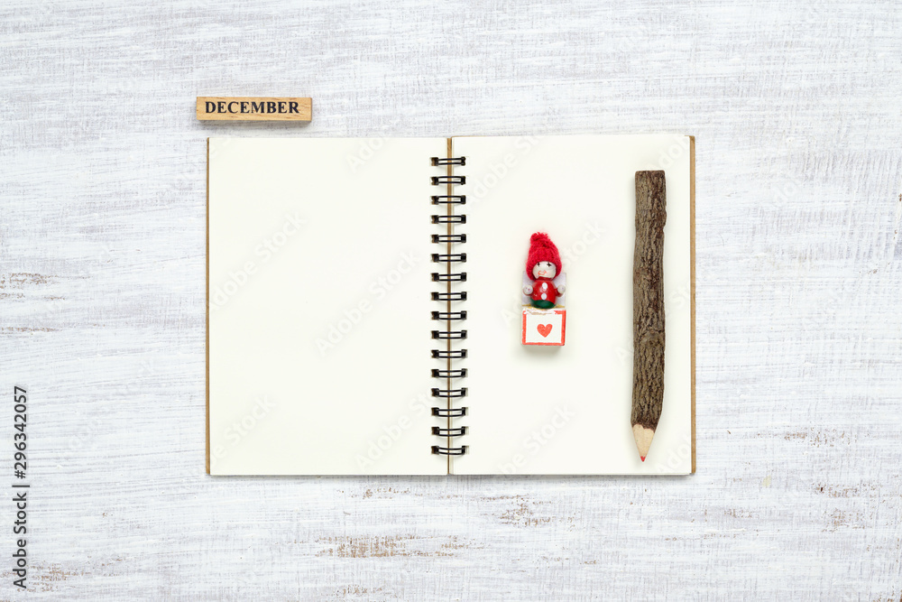 Aufkleber top view of blank notebook on grunge white wood background with xmas toy decorations. mockup christm
