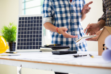 Team Engineers are writing solar panel for home construction designs to bring them to prospective customers.concept