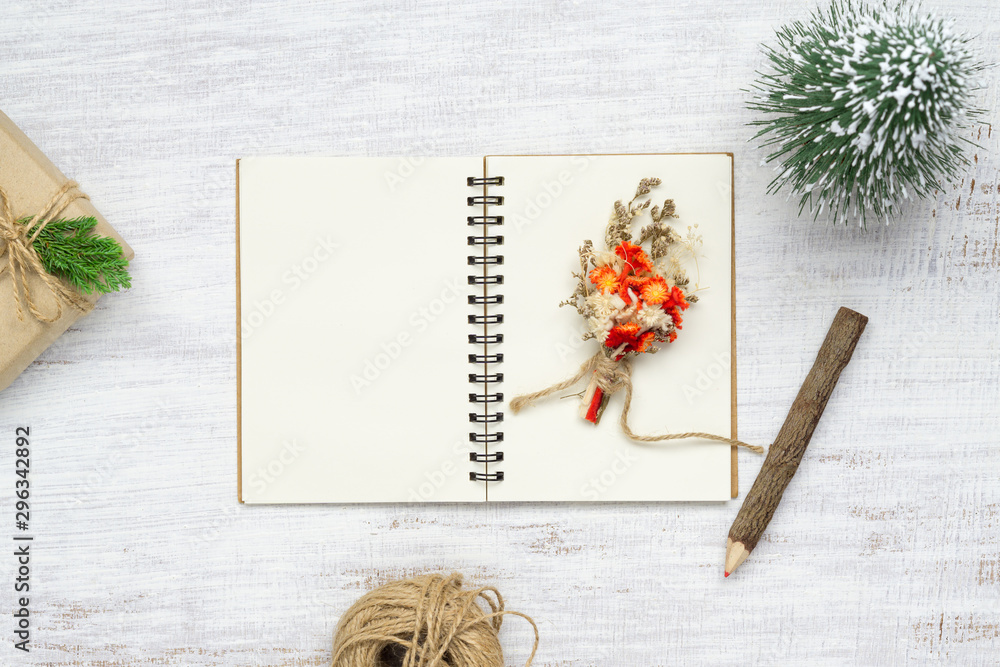 Aufkleber top view of blank notebook on grunge white wood background with xmas toy decorations. mockup christm