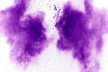 Purple color powder explosion cloud  on white background.Closeup of purple dust particles splash on background.