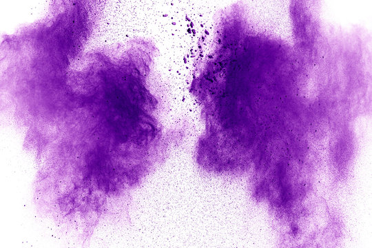 Purple Color Powder Explosion Cloud  On White Background.Closeup Of Purple Dust Particles Splash On Background.