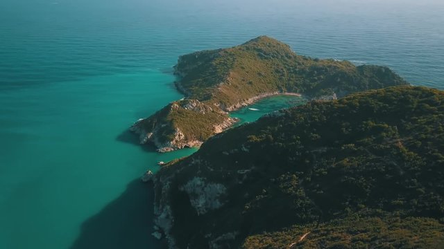 Aerial view from the popular tween beach at Corfu Island in Greece. A double-mirrored-gulf beach surrounded by vivid water in an unrealistic way