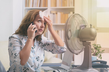 Woman suffers from heat in the office or at home