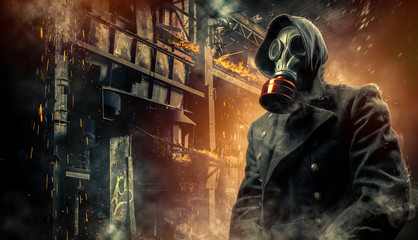 Man in a gas mask on an industrial background