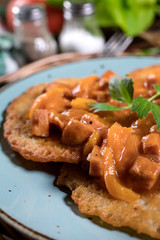 Homemade potato pancakes with goulash.
