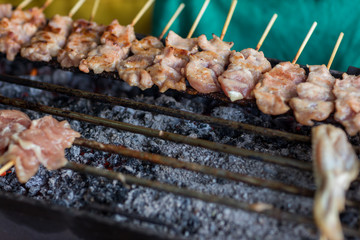 Barbecue pork Toast grill or Toast pork with Thai garnish nutrition preparation for cooking. Thai food, Street food. Pork satay grilling on stove or Thai style roasted pork at the market.