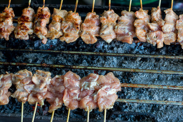 Barbecue pork Toast grill or Toast pork with Thai garnish nutrition preparation for cooking. Thai food, Street food. Pork satay grilling on stove or Thai style roasted pork at the market.