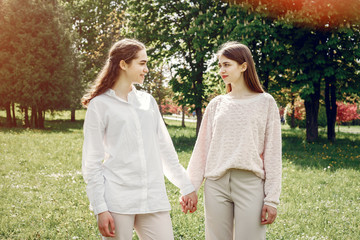 Fototapeta na wymiar Beautiful two sisters. Women in a summer park