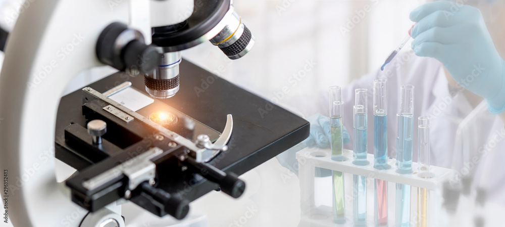 Wall mural close-up shot of microscope with metal lens at laboratory with blurred background of scientist use d