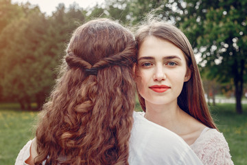 Beautiful two sisters. Women in a summer park