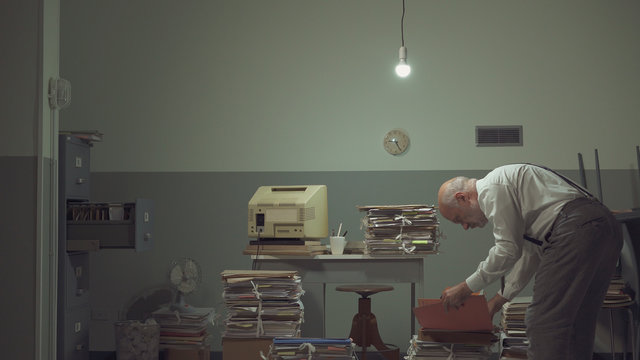 Businessman working in a messy office