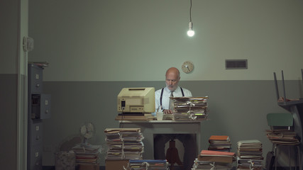 Frustrated businessman overloaded with paperwork