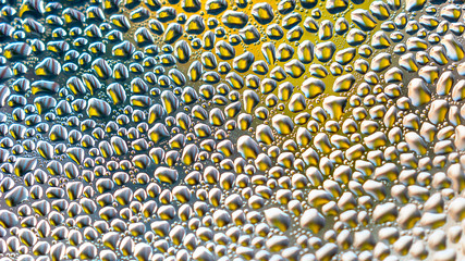 Colorful Raindrops on Glass with Blurred Vibrant Multicolor Abstract Background.