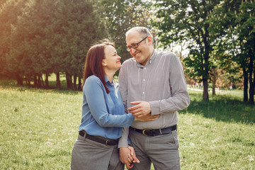 Couple in a forest. Adult pair walking. Lady in a blue shirt