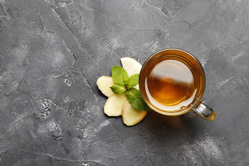 Tea with mint, ginger and lemon. Hot drink On a wooden background. Top view. Copy space.
