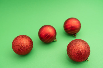 Christmas-tree decorations on green background. Composition of Christmas toys. Top view, flat lay.
