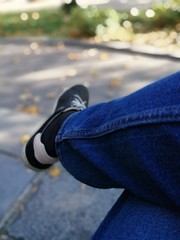 Male legs wearing denim trousers sneakers casual style walking relax 